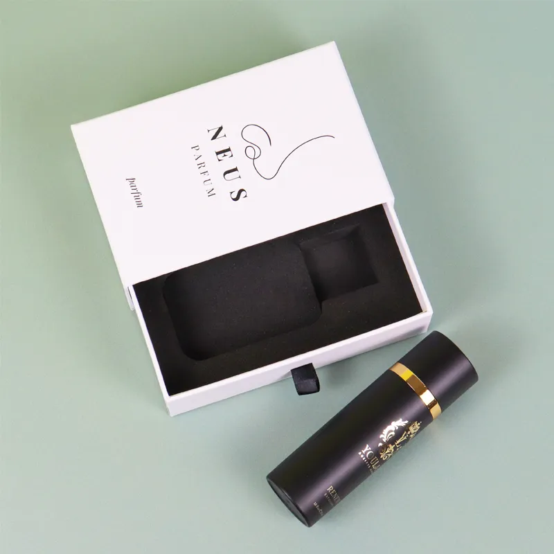 Angled open minimalist perfume boxes with black cologne bottle placed inside tailor-cut dual-slot EVA foam insert
