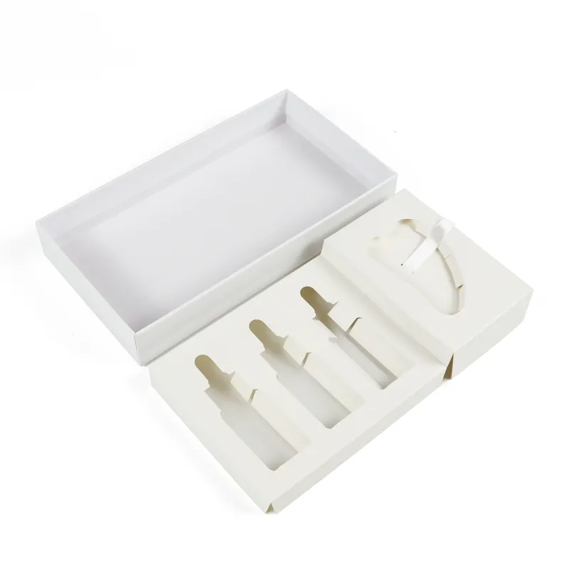 Slanted overhead view of white rigid window box with removable custom die-cut insert tray