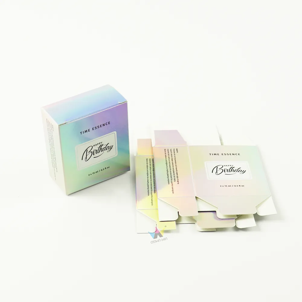 Assembled holographic iridescent tuck folding carton paired with flat blank die-cut sheets for serum bottle packaging