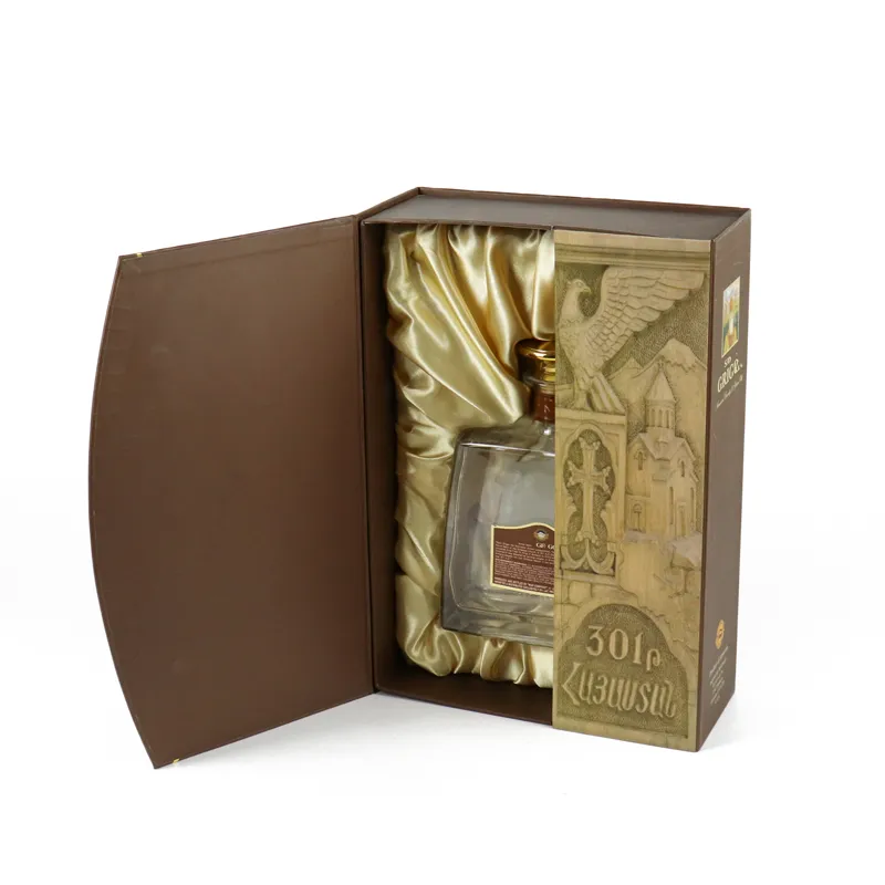 Opened brown rigid double door box, luxury wine gift packaging with golden gathered satin lining and liquor bottle inside
