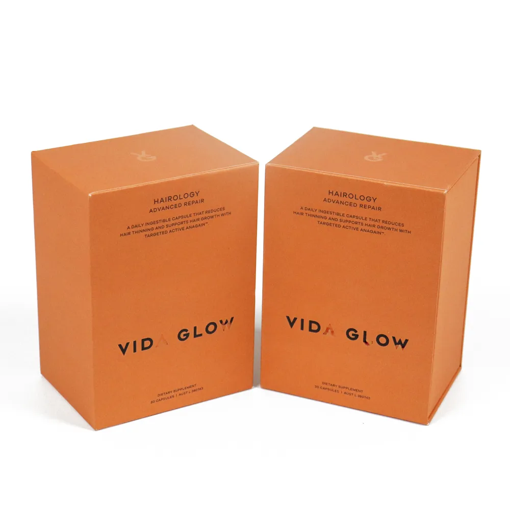 Front close-up shot of printed brand name, product description text on matte orange slide drawer perfume boxes