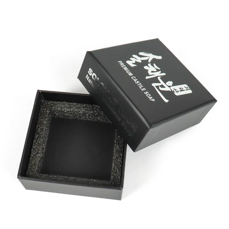 Close-up of shiny gold hot foil Korean calligraphy logo on white lid and base box surface