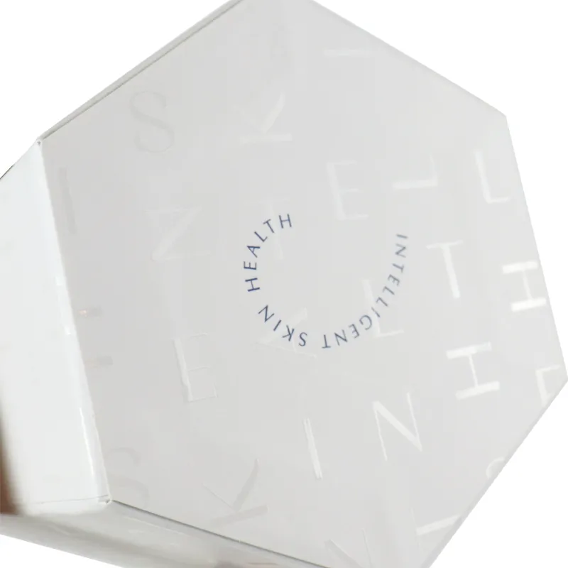 Macro close-up blind embossed subtle letter texture detail on the white lid of hexagonal lid and base box
