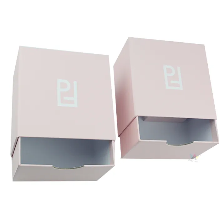 Close-up detail of semi-circular finger pull tab cutout on front panel of matte pink slide sleeve essential oil boxes