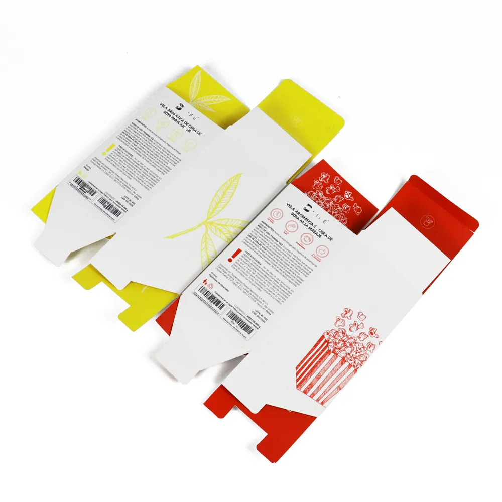 Two closed white tuck folding cartons with custom exterior graphics, caramel popcorn and creamy mango candle designs