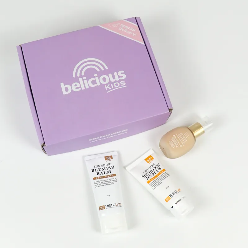Flat display of custom printed tuck folding cartons paired with full skincare kit including foundation, sunscreen and blemish balm tubes