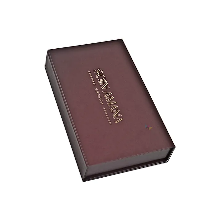 Closed matte burgundy magnetic flip lid skincare packaging box with elegant gold foil hot stamped brand logo on top surface