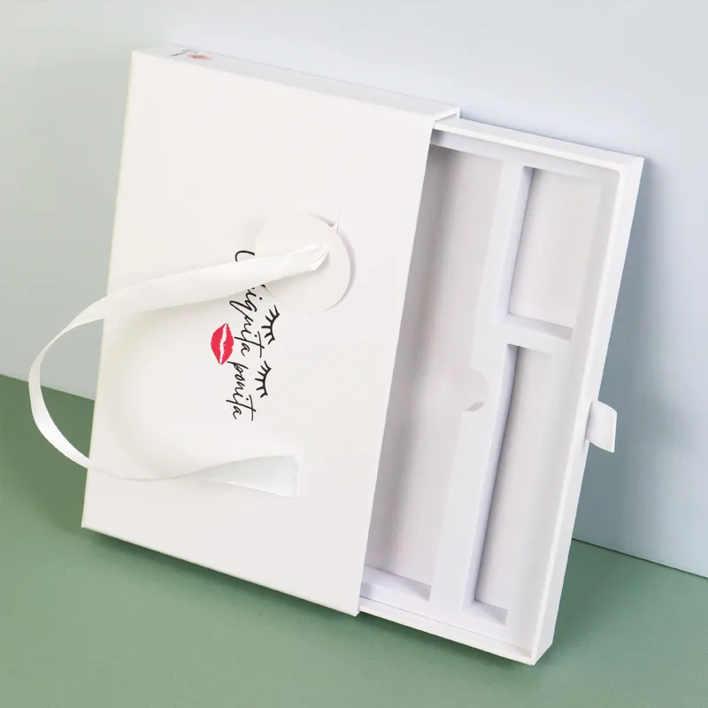 Closed matte white cosmetic boxes front view with wide satin ribbon handle, custom printed eyelash lip graphic logo on cover
