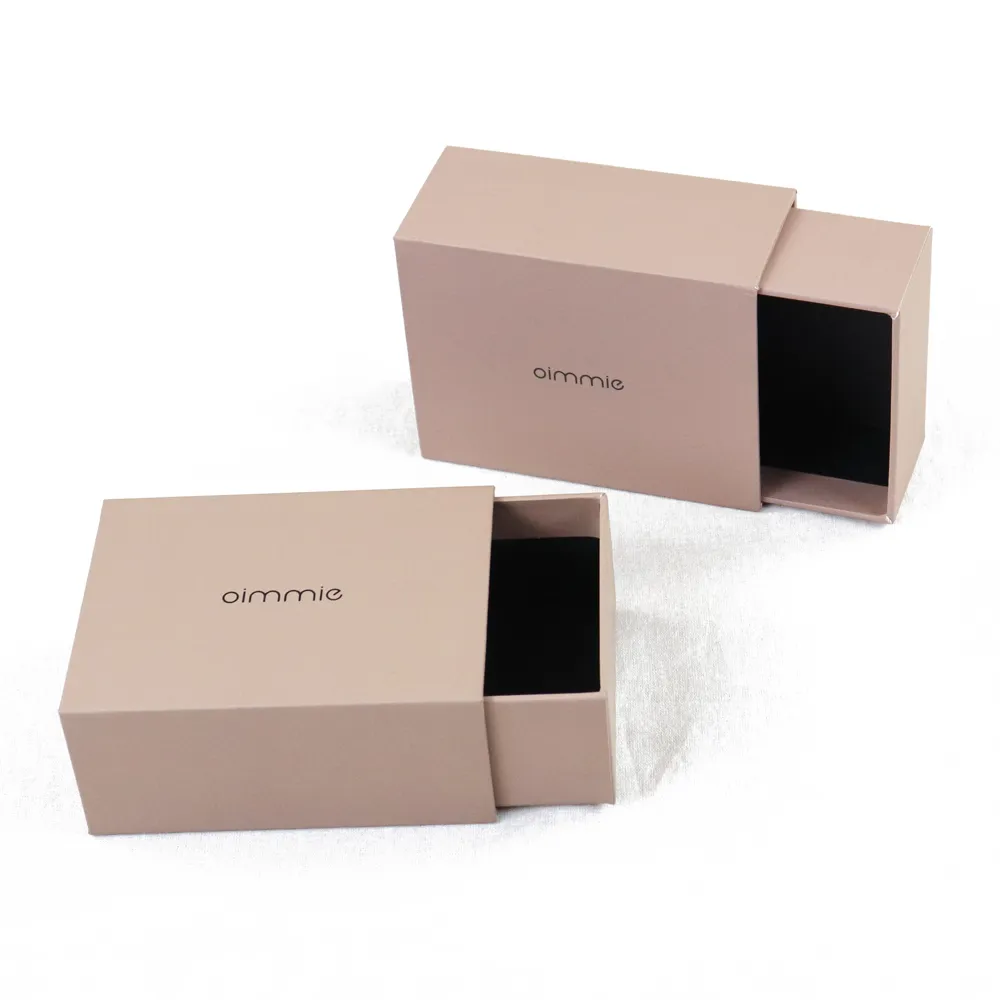 Closed nude blush matte slide drawer perfume boxes with subtle custom debossed brand text logo on flat top surface