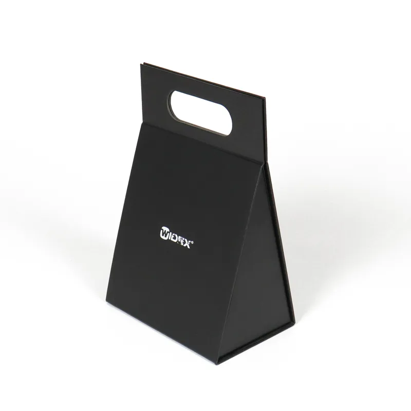 Closed front view matte black triangle folding box with printed white brand logo and top oval cutout carry handle, portable cosmetic triangle folding box