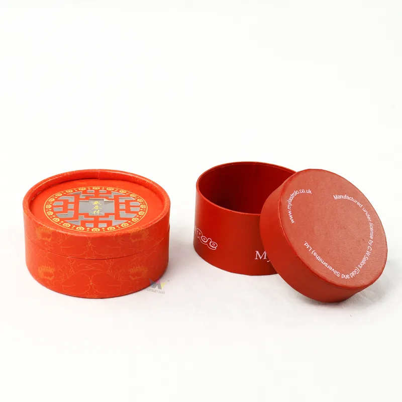 Closed red printed cylinder boxes, short round paper tube with decorative hollow window cutout lid