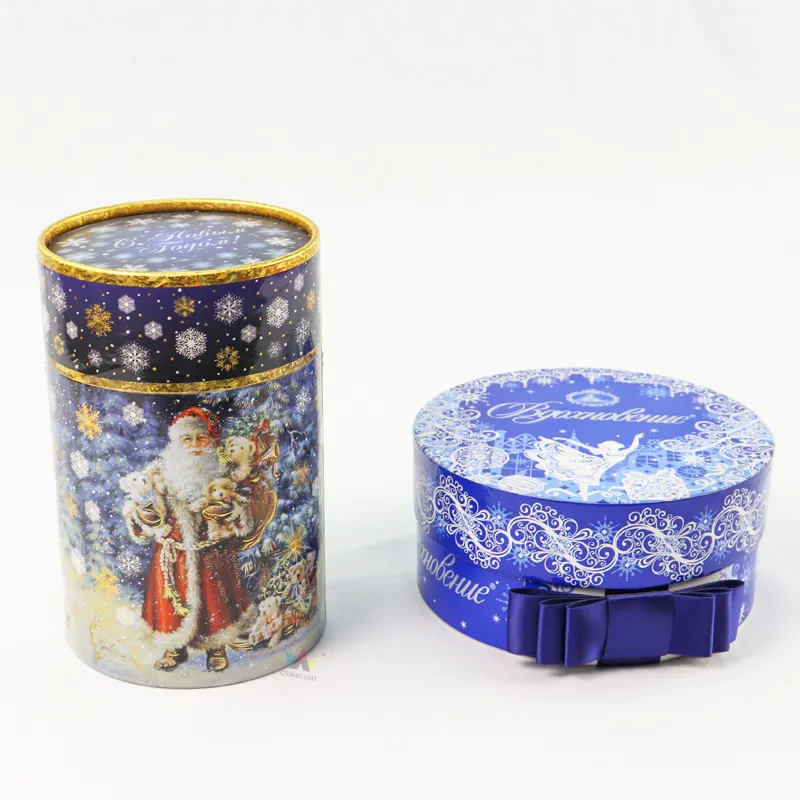 Vertical front view closed Santa snowflake cylinder boxes, seasonal printed paper tube with gold rim