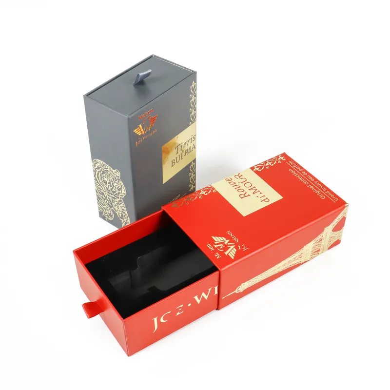 Standing closed dark grey rigid perfume boxes, full intricate gold foil decorative print and brand emblem front shot