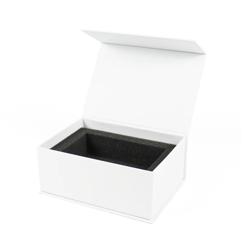 Closed three-quarter view of white magnetic gift box decorated with gold foil border and brand logo