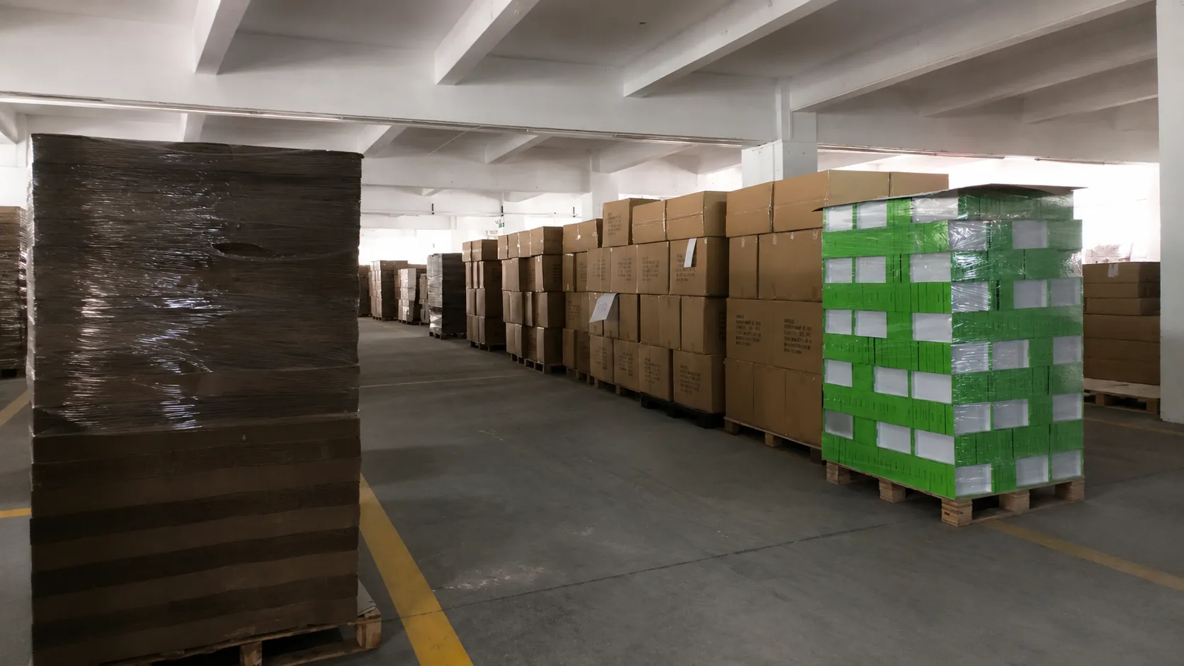 Warehouse storage of stackable custom sized paper boxes at Crown Win Box Manufacturer, optimized dimensions to maximize container space and cut shipping expenses