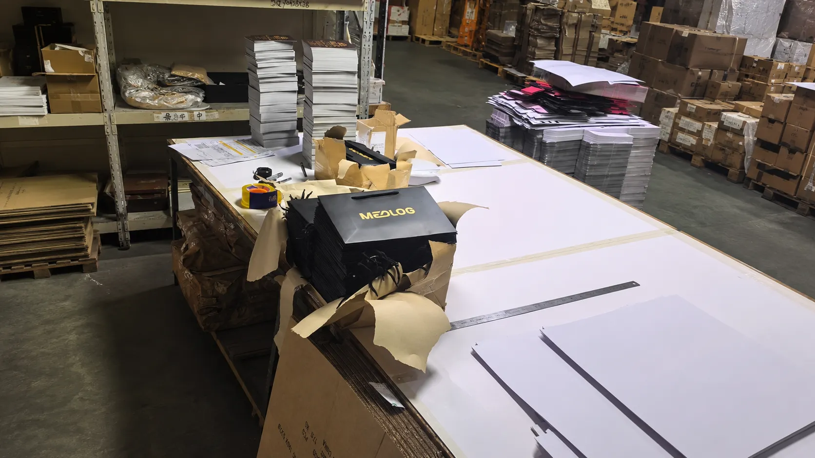 Inside Crown Win Box Manufacturer’s sampling workshop with paper sheets, custom tote bag prototypes and raw packaging materials showing our factory sampling production strength