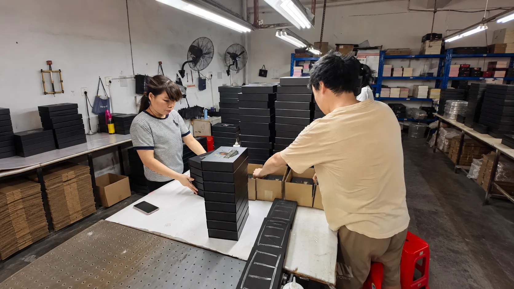 Crown Win Box Manufacturer factory workshop, workers inspect finished custom cosmetic and perfume packaging boxes
