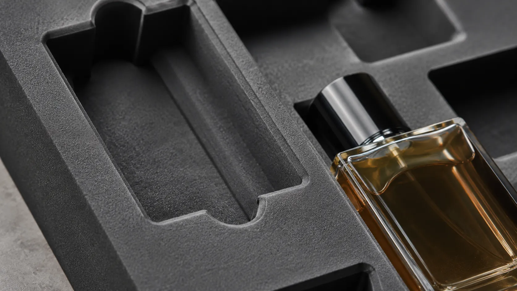 Custom black CNC cut EVA insert for luxury perfume glass bottle, shockproof cosmetic box inner tray from Crown Win Box Manufacturer