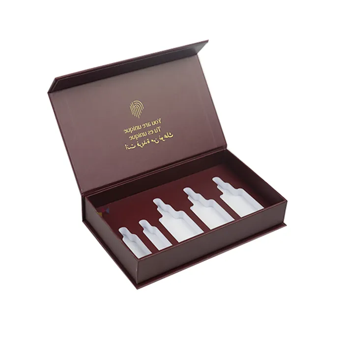 Empty open luxury magnetic skincare packaging fitted with custom CNC molded white EVA insert featuring five mixed-size bottle cavities