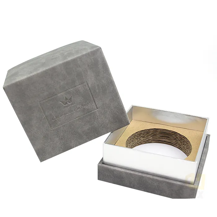 Closed square neutral grey suede candle boxes front view, subtle blind debossed framed crown brand logo on matte textured lid surface
