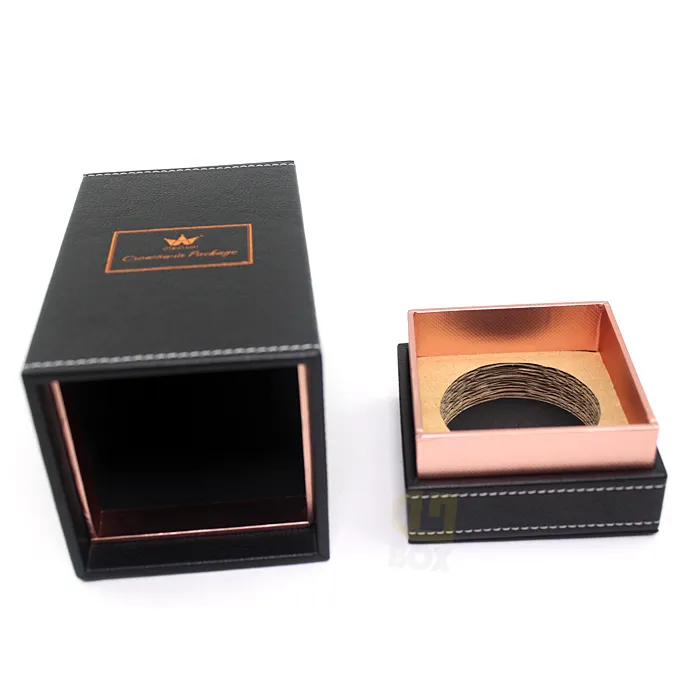 Exploded two-piece black faux leather stitched candle boxes, separated lid and base with shiny rose gold inner tray and eco corrugated circular candle insert
