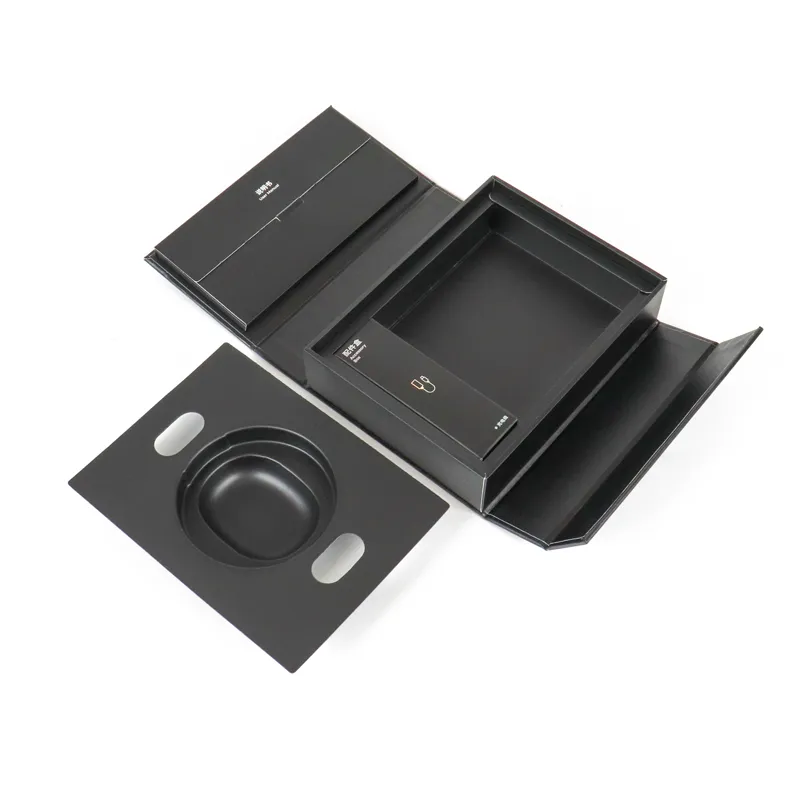 Exploded layout of double door box, separated rigid case, molded paper insert and accessory storage tray
