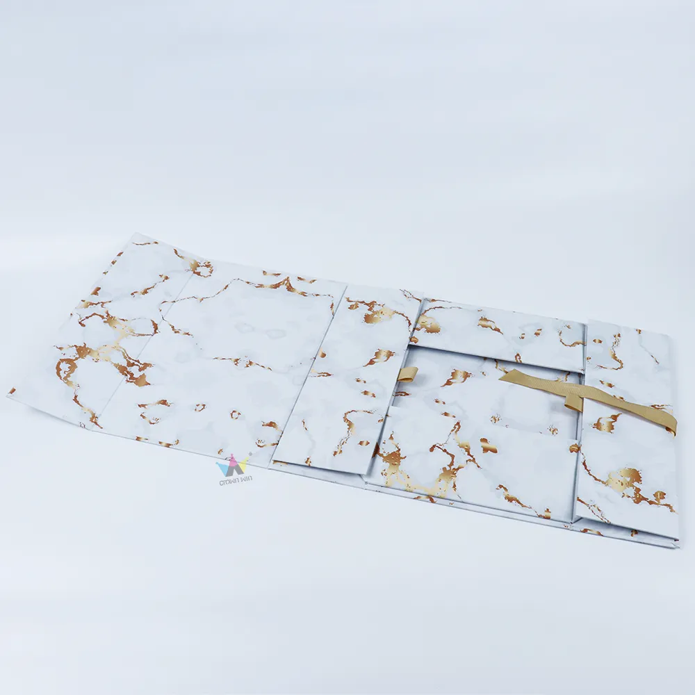 Fully opened marble print one-piece folding box showing empty full marble interior and golden ribbon pull tab
