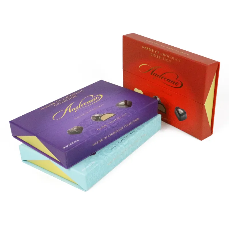 Wide fully opened purple double door box revealing gold plastic blister tray with multiple chocolate slots, luxury confectionery gift packaging