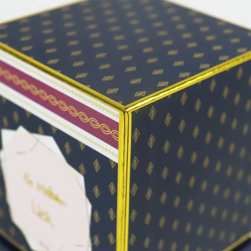 Macro detail of shiny gold foil edge trimming and decorative border on the corner of square printed lid and base box