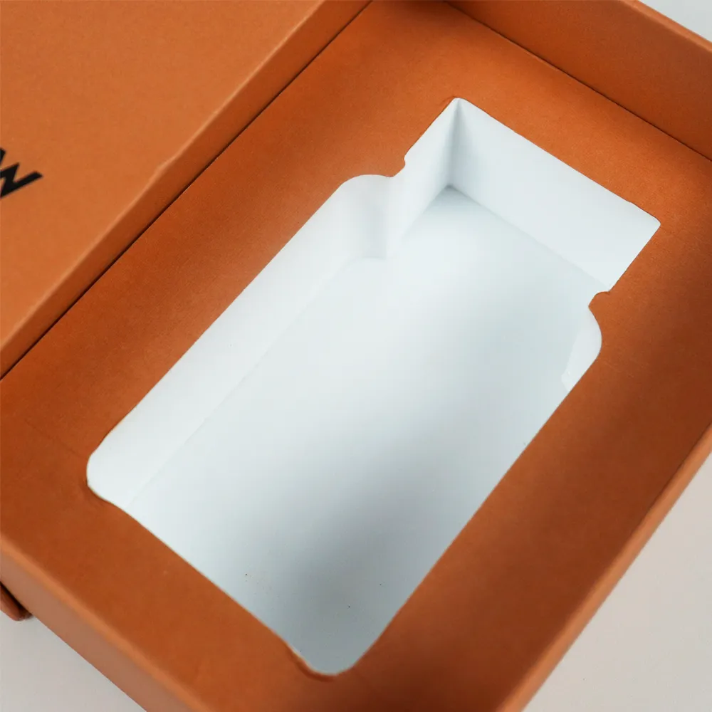 Macro detail view of smooth precision die-cut single bottle recess cavity inside paper insert for slide drawer perfume boxes