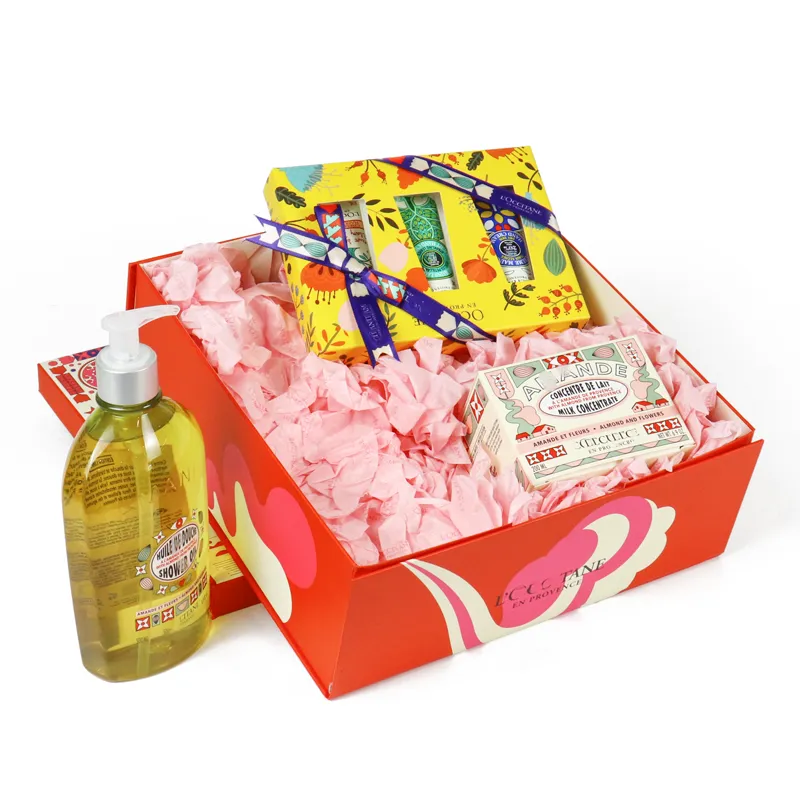 Matching printed paper gift bag paired with rigid flip lid skincare packaging box with seasonal illustration design