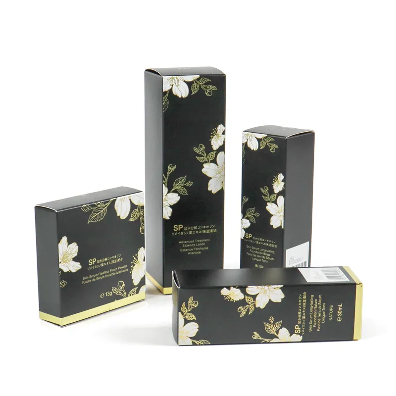 One open, one closed gold floral print tuck folding carton, foldable luxury packaging for liquid foundation cosmetic products