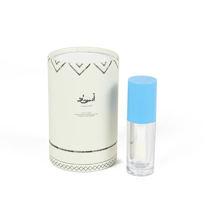 Disassembled luxury paper cylinder box, empty round tube lid, hollow white inner tray and transparent attar oil vial beside custom printed cylinder box
