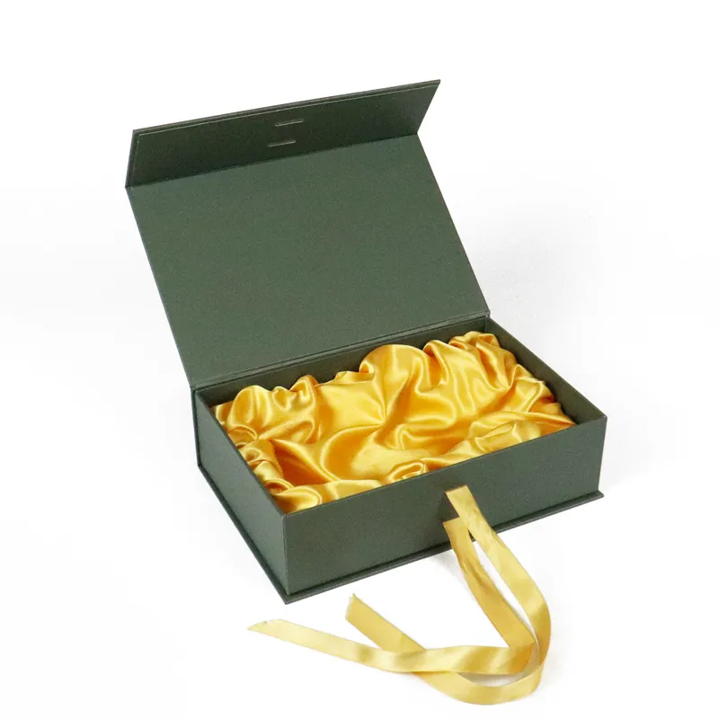Opened matte dark green magnetic closure boxes, luxury olive oil gift box lined with gathered golden satin fabric