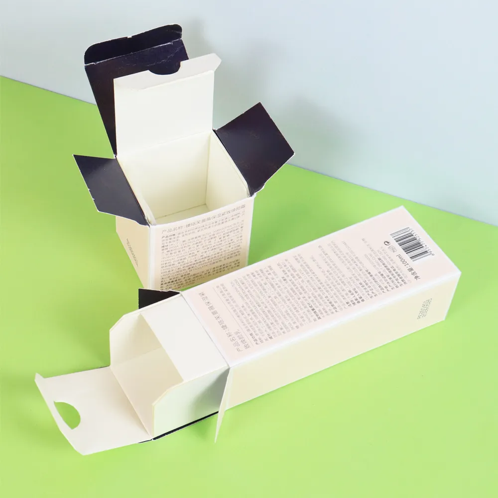 Angled open empty vertical and square tuck cartons made of textured cream coated cosmetic paperboard