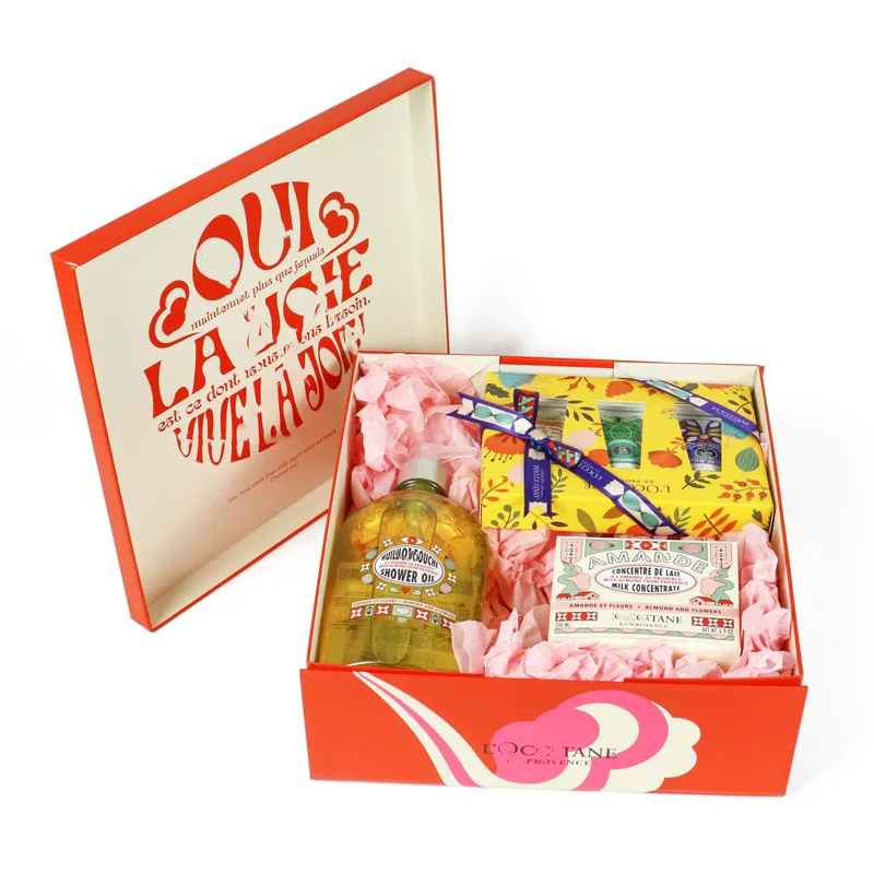 Open illustrated flip lid skincare packaging gift box holding shower oil, hand cream and assorted bath & body cosmetic products