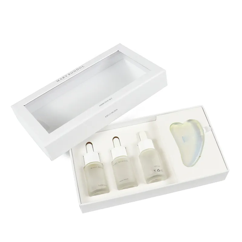 Opened white window gift box showing custom precision die-cut insert holding serum bottles and gua sha stone