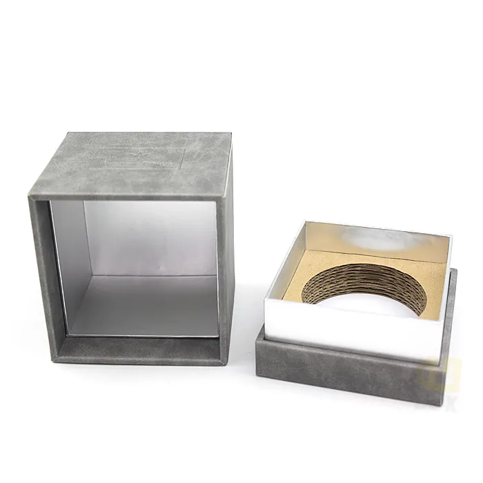 Open grey suede rigid candle box with lid tilted aside, showcasing shiny silver metallic lined tray fitted with eco corrugated candle holder ring