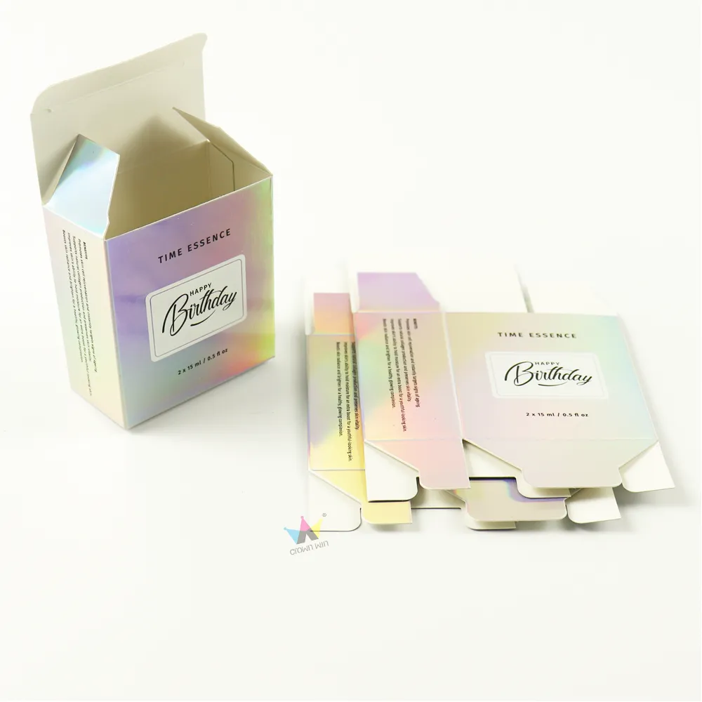 Opened reverse tuck folding carton made of shimmer holographic iridescent paper, cosmetic bottle packaging
