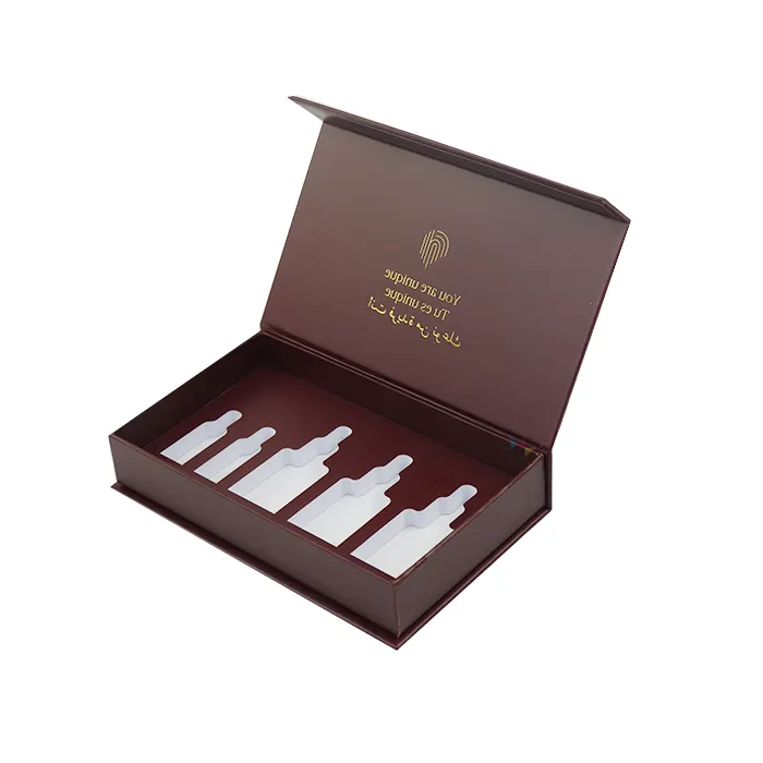 Top down overhead view of open burgundy skincare gift packaging displaying five graduated bottle slots inside shockproof EVA liner