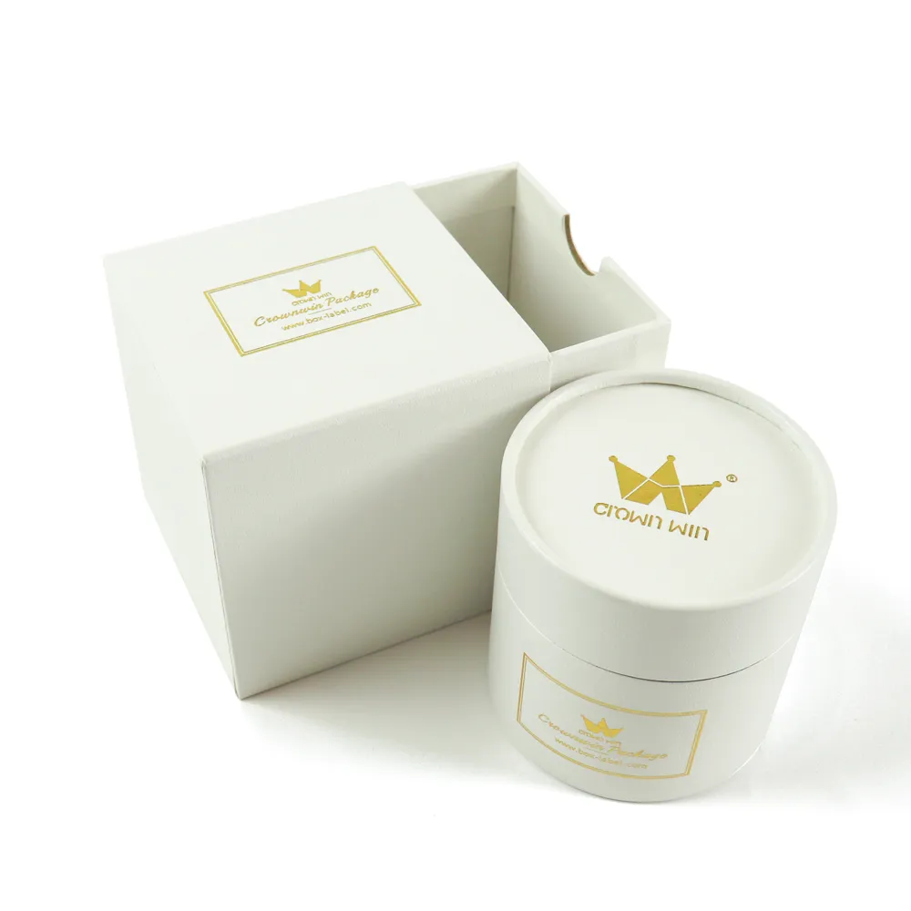 Overhead top view minimalist white matte drawer style candle boxes with custom hot foil logo printed round tube lid insert