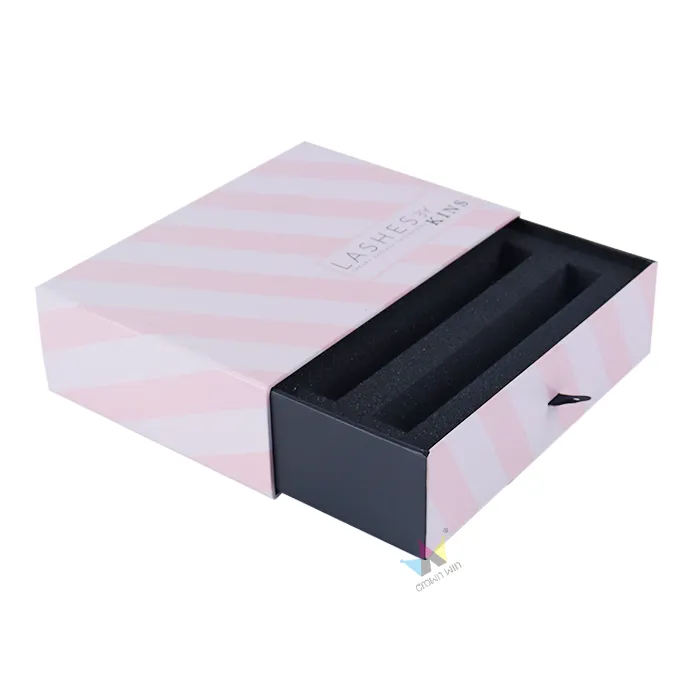 Top-down overhead shot of open eyelash extension drawer box, snug fit custom molded foam insert inside slide drawer