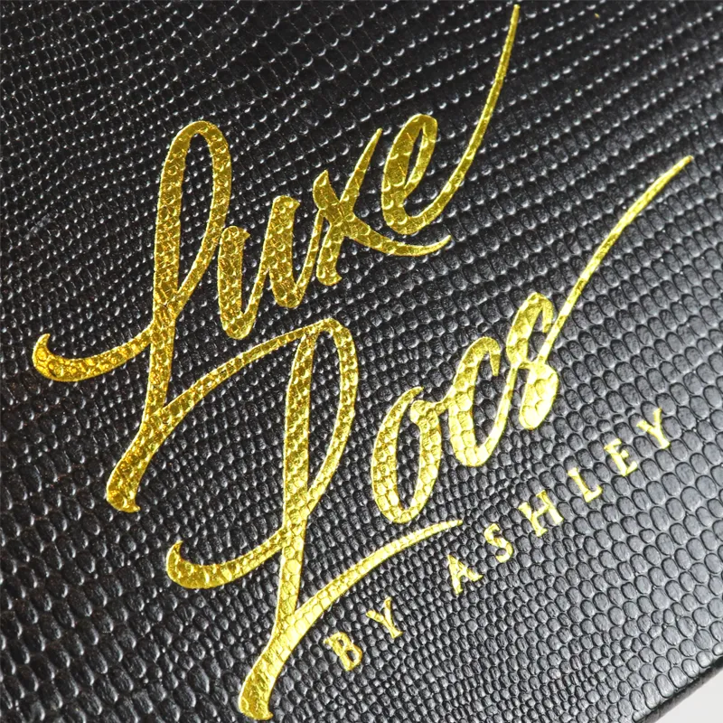 Top overhead shot of empty foam slots inside magnetic closure boxes, highlighting bright gold inner tray rim luxury finish