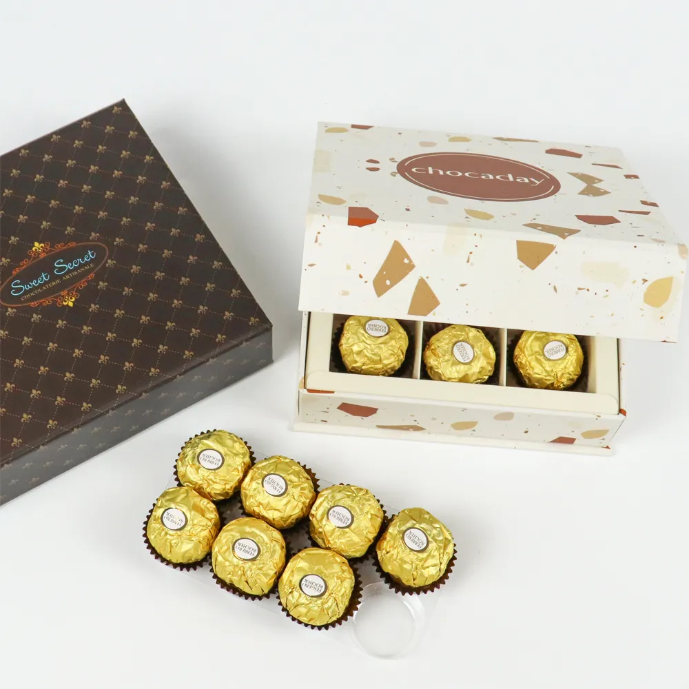 Partially opened square magnetic box showing 3-compartment divided paper insert for individual wrapped candy, chocolate magnetic gift box