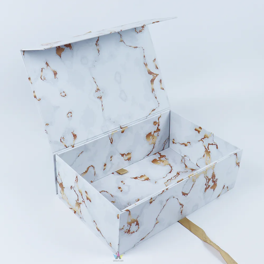 Semi-assembled white marble one-piece folding box demonstrating magnetic flip lid and satin ribbon pull tab design