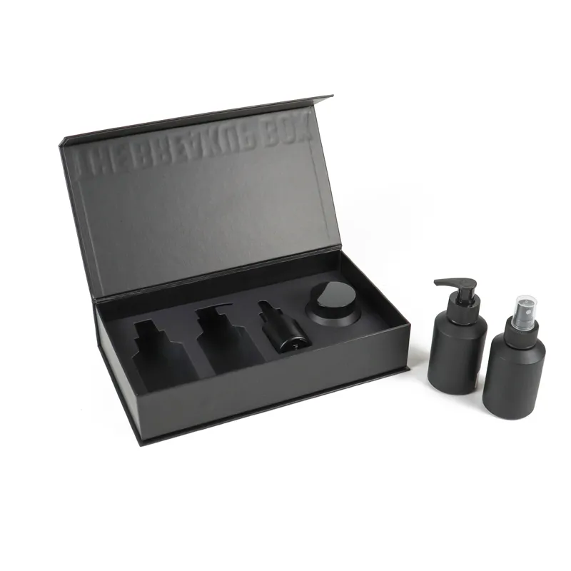 Separated layout of blank CNC foam insert tray and empty matte black magnetic cosmetic boxes shell with loose beauty containers placed beside