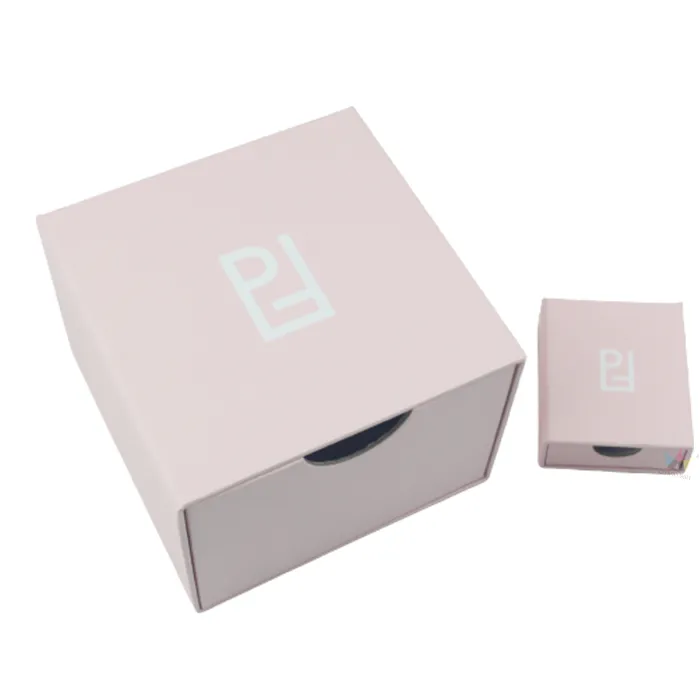 Side profile shot of fully closed rigid pink slide drawer essential oil boxes featuring minimalist white brand logo print