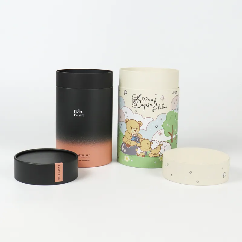 Side close-up of gradient fade cylinder boxes, matte black to dusty peach print with minimal brand text and side label tag detail