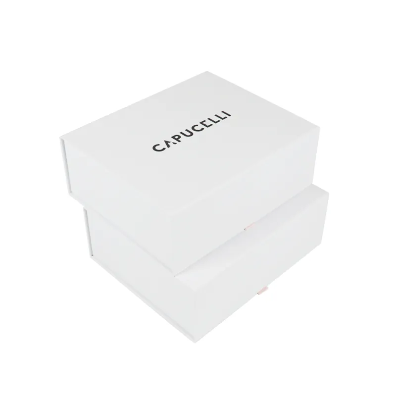 Side angled shot of open flip lid cosmetic boxes showcasing pink satin ribbon pull-out bottom storage drawer tier