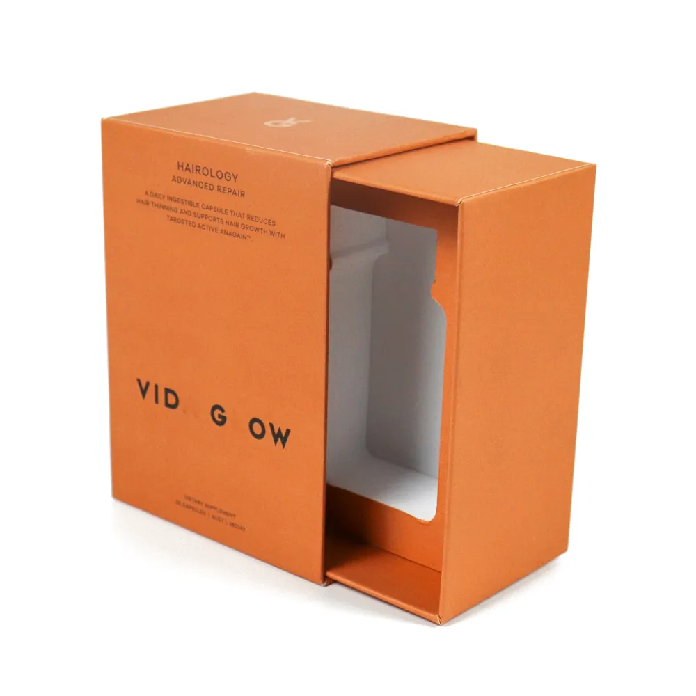 Side angled partial open shot of empty orange slide drawer perfume boxes rigid cardboard packaging shell without products"